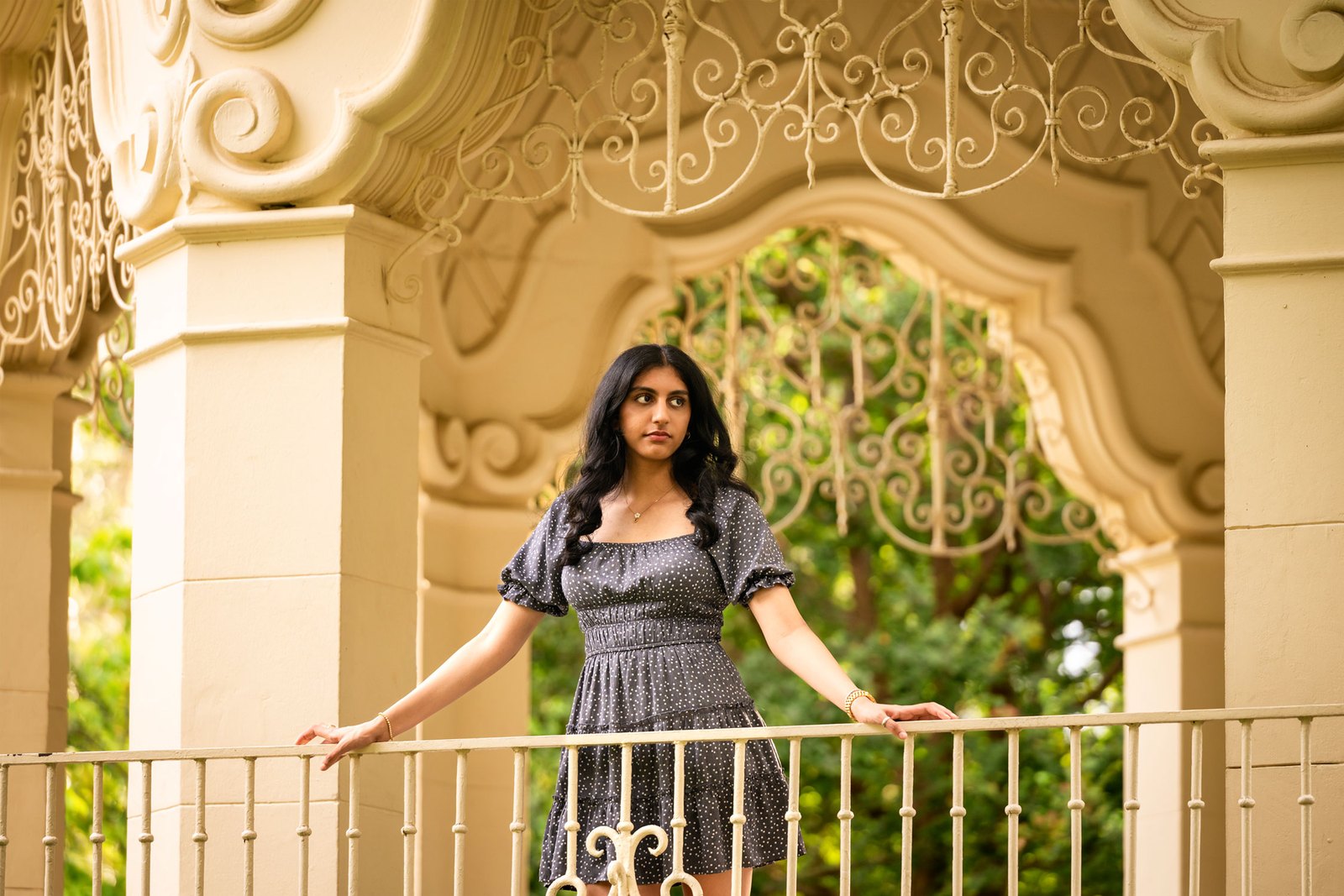 An editorial senior portrait beneath the ornate gazebo at Flippen Park