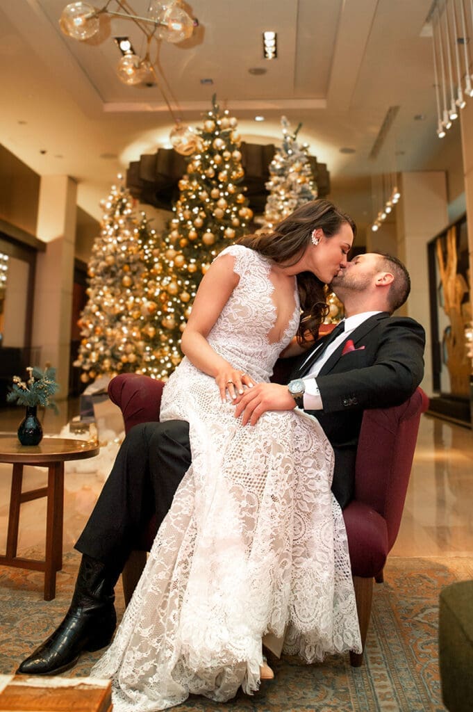 Bride and groom sharing a quiet moment in the moody, art-filled lobby of The Joule hotel during their winter wedding.